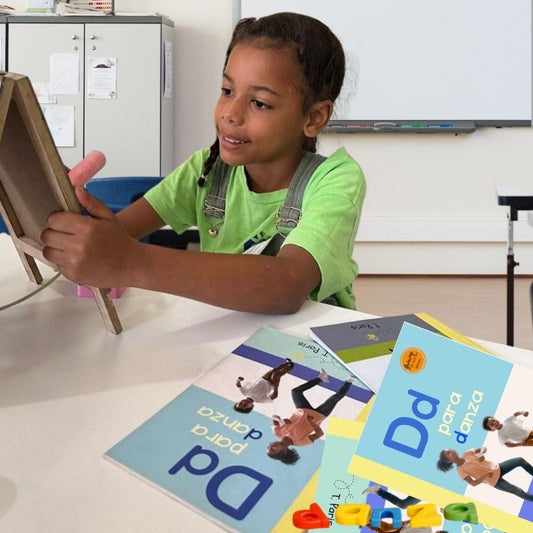 Child using a tablet with educational books on a table