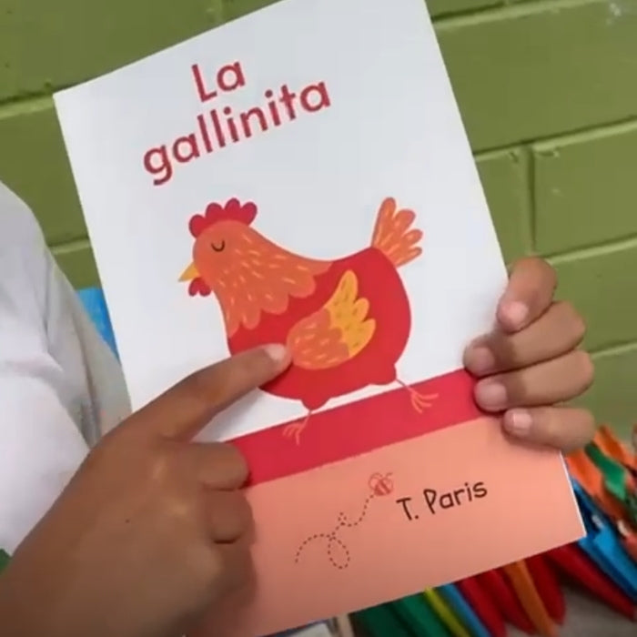 Children's book titled 'La gallinita' with a colorful illustration of a chicken held by two hands.