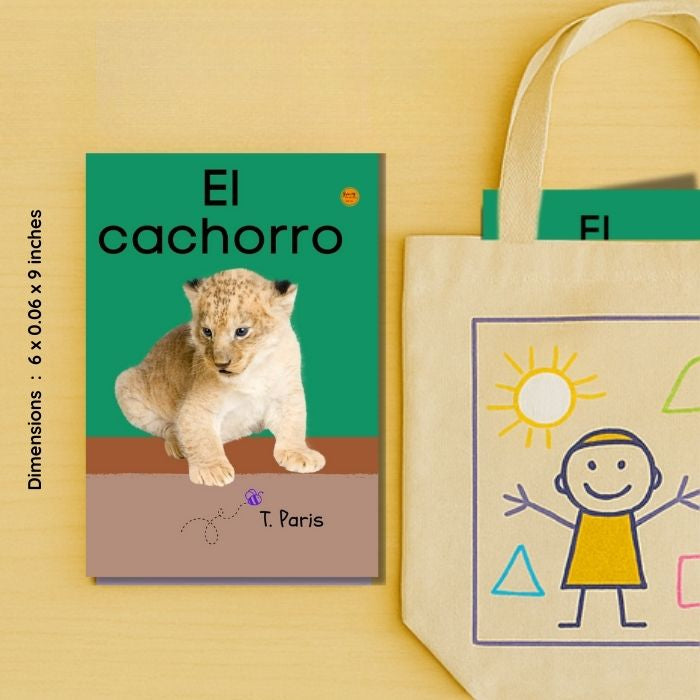 Children's book titled 'El cachorro' with a lion cub illustration, next to a tote bag with a child and sun design on a yellow background.