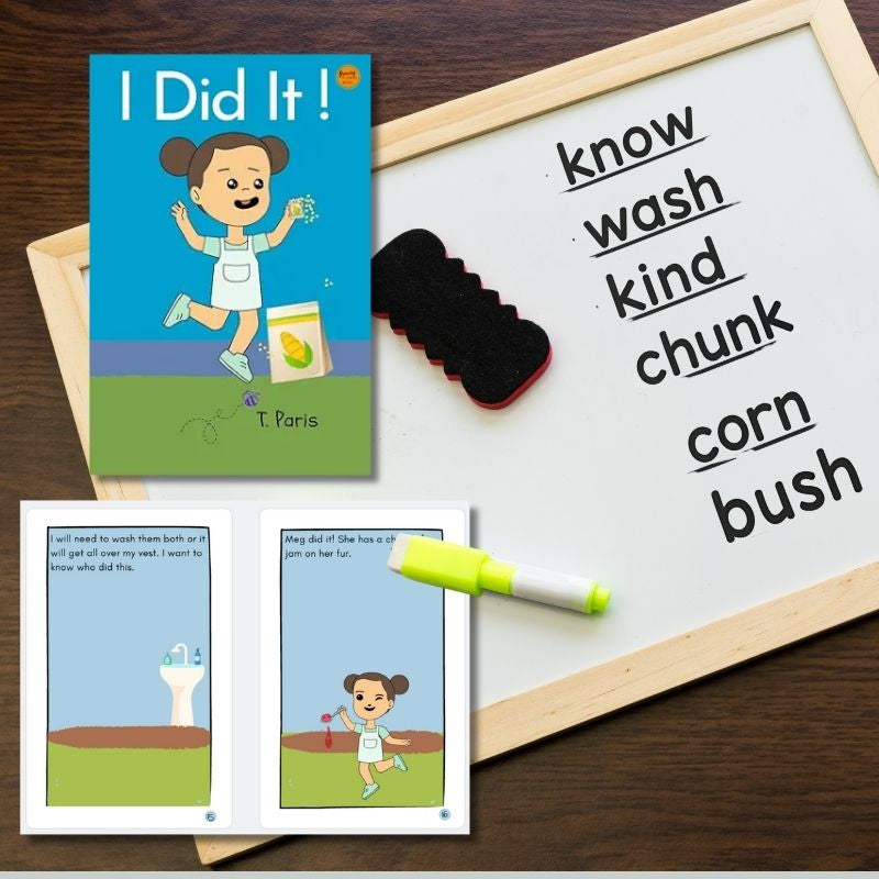 Children's book titled 'I Did It!' with flashcards and a whiteboard on a wooden surface.